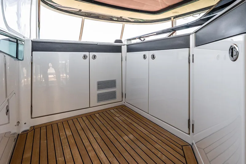 Slide: The Image of Interior view of 2022 Absolute 64 Navetta yacht with sleek cabinetry and wooden flooring. - 44