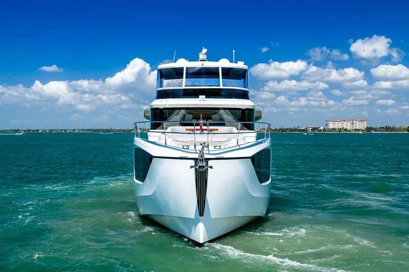 Slide: The Image of Front view of 2022 Absolute 64 Navetta yacht on clear blue water. - 18