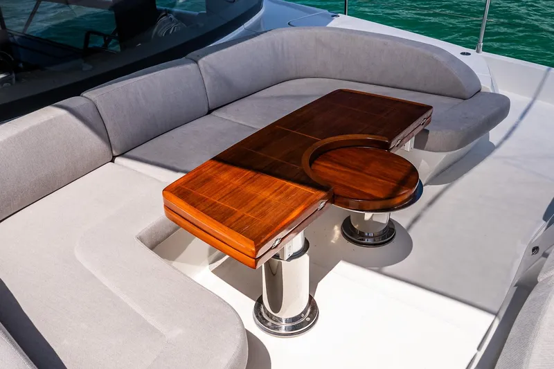Slide: The Image of Luxurious seating area on 2022 Absolute 64 Navetta yacht with elegant wooden table. - 28