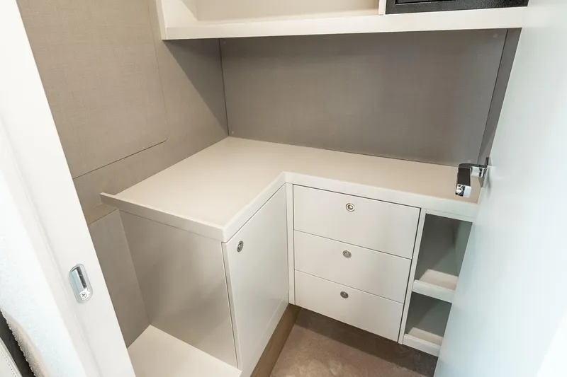 Slide: The Image of Compact storage area in 2022 Absolute 64 Navetta yacht, featuring sleek white cabinetry. - 101