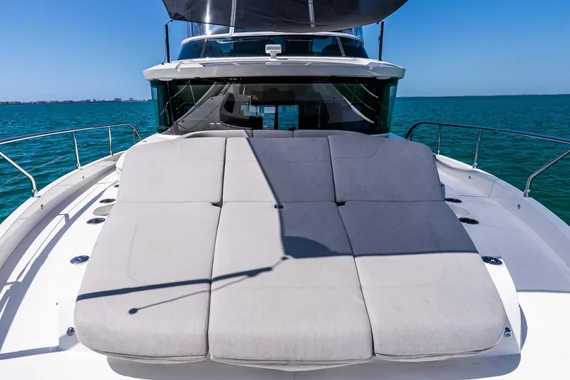 Slide: The Image of Luxurious 2022 Absolute 64 Navetta yacht with spacious sunbed on open sea. - 25