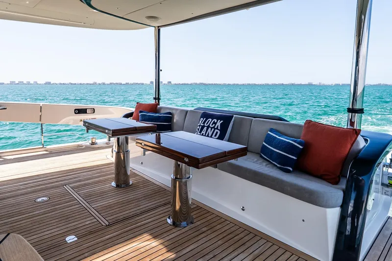 Slide: The Image of Luxury deck of 2022 Absolute 64 Navetta yacht with ocean view and comfortable seating. - 62