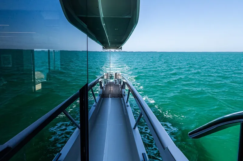 Slide: The Image of Side view of 2022 Absolute 64 Navetta yacht cruising on turquoise waters. - 52