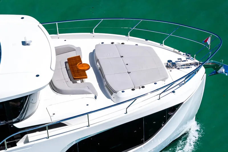 Slide: The Image of Luxurious 2022 Absolute 64 Navetta yacht with sunbathing area and elegant deck design. - 23