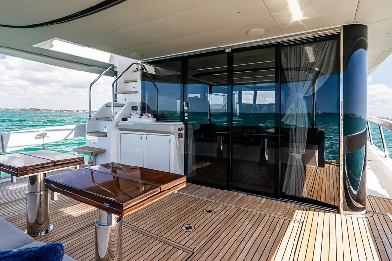 Slide: The Image of Luxurious 2022 Absolute 64 Navetta yacht deck with elegant wood finish and ocean view. - 58