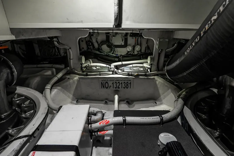 Slide: The Image of Engine room of 2022 Absolute 64 Navetta yacht, showcasing mechanical components and piping. - 110