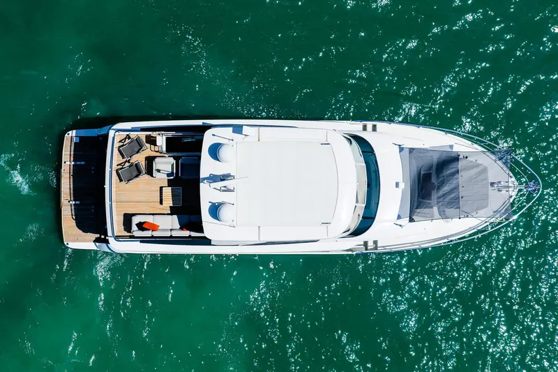 Slide: The Image of Aerial view of 2022 Absolute 64 Navetta yacht on sparkling green water. - 21