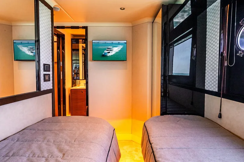 Slide: The Image of Luxurious interior of 2022 Absolute 64 Navetta yacht with twin beds and TV. - 98