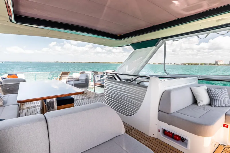 Slide: The Image of Luxurious 2022 Absolute 64 Navetta yacht interior with ocean view and elegant seating area. - 46