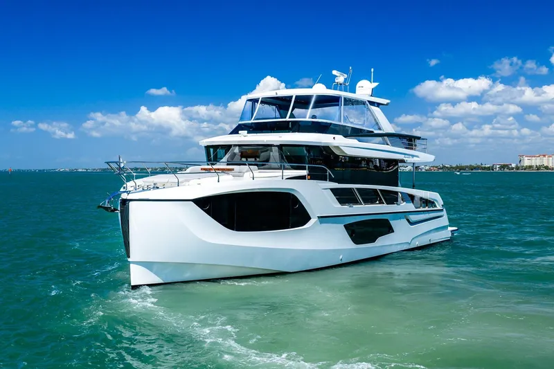 Slide: The Image of Luxurious 2022 Absolute 64 Navetta yacht cruising on clear blue waters. - 15