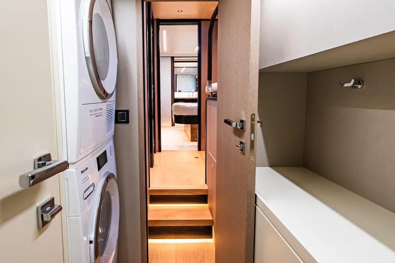 Slide: The Image of Laundry area and hallway inside 2022 Absolute 64 Navetta yacht. - 102