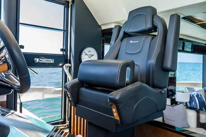 Slide: The Image of Luxurious captain's chair on 2022 Absolute 64 Navetta yacht, overlooking ocean view. - 77