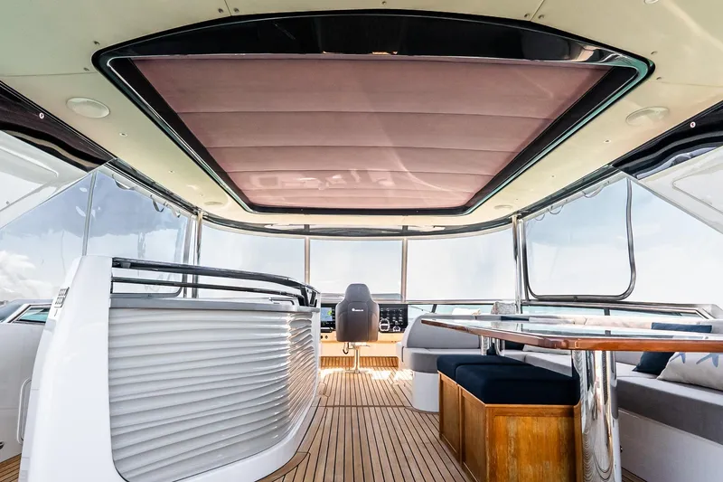 Slide: The Image of Luxurious interior of 2022 Absolute 64 Navetta yacht with modern seating and panoramic windows. - 42