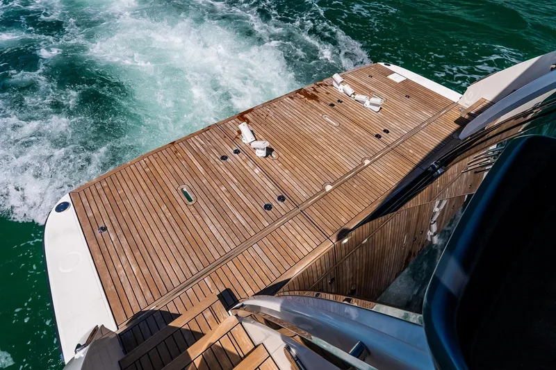 Slide: The Image of Luxury yacht Absolute 64 Navetta 2022, featuring elegant teak deck and ocean backdrop. - 57