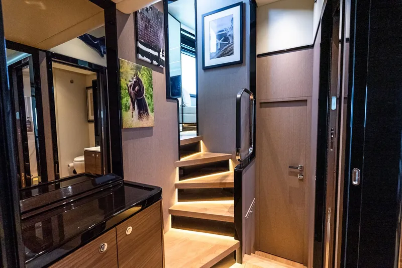 Slide: The Image of Luxurious interior of 2022 Absolute 64 Navetta yacht with elegant staircase and modern decor. - 95
