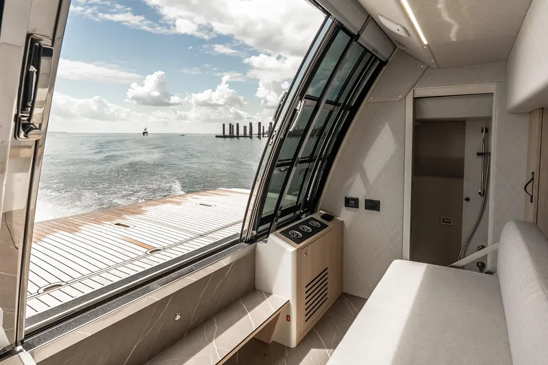 Slide: The Image of Interior view of 2022 Absolute 64 Navetta yacht with ocean backdrop. - 55