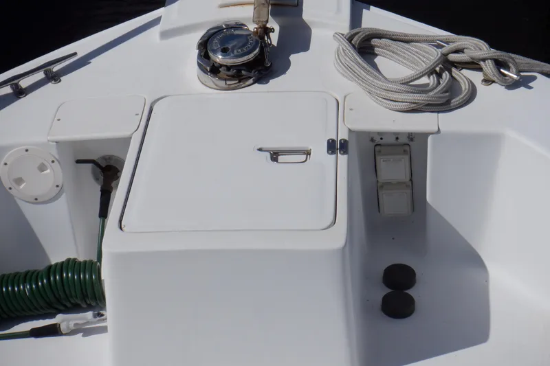 Slide: The Image of 1999 Mainship 350 Trawler deck with rope, hatch, and winch. - 15