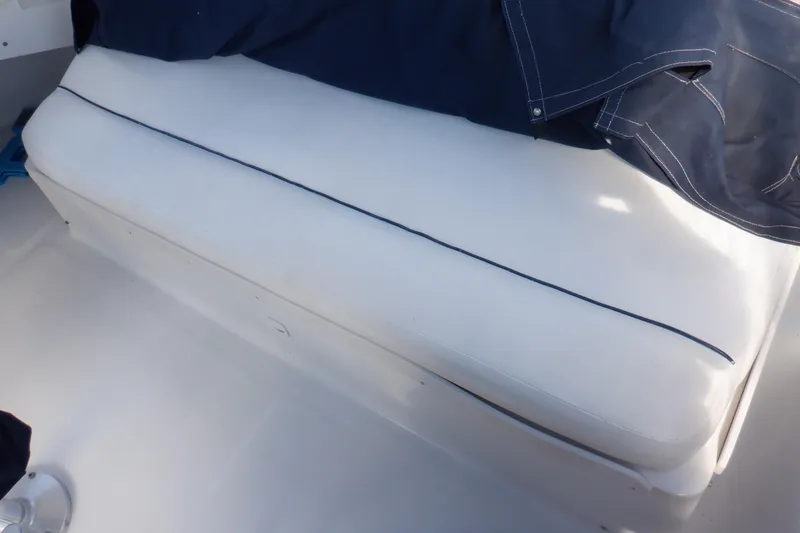 Slide: The Image of White cushioned seat on 1999 Mainship 350 Trawler boat deck. - 18