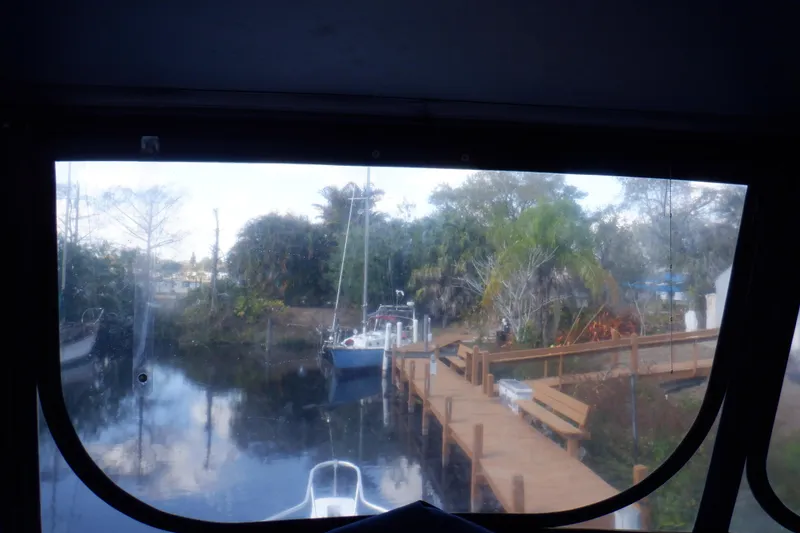 Slide: The Image of View from 1999 Mainship 350 Trawler, overlooking dock and lush greenery. - 19