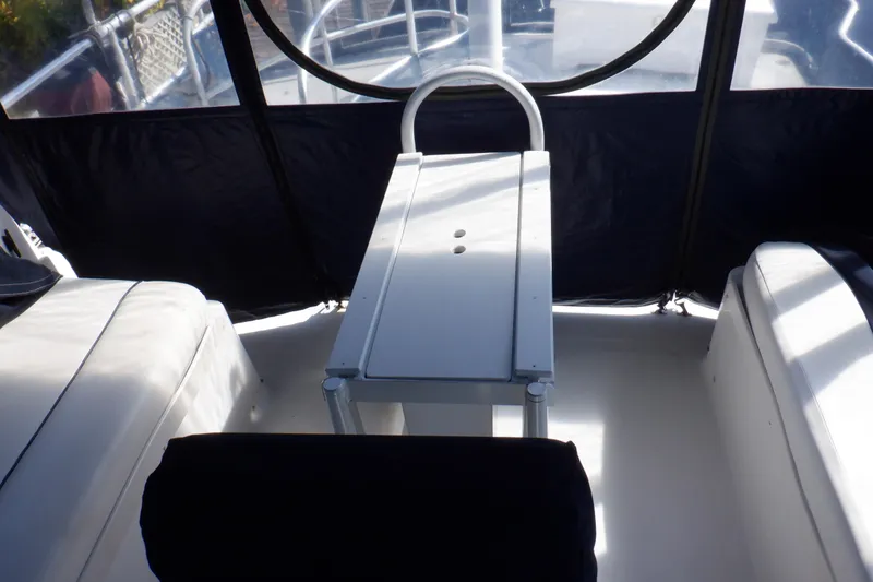 Slide: The Image of Interior view of 1999 Mainship 350 Trawler with seating and table. - 24