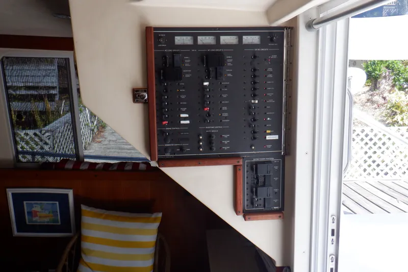 Slide: The Image of Electrical panel inside 1999 Mainship 350 Trawler, featuring switches and controls. - 31