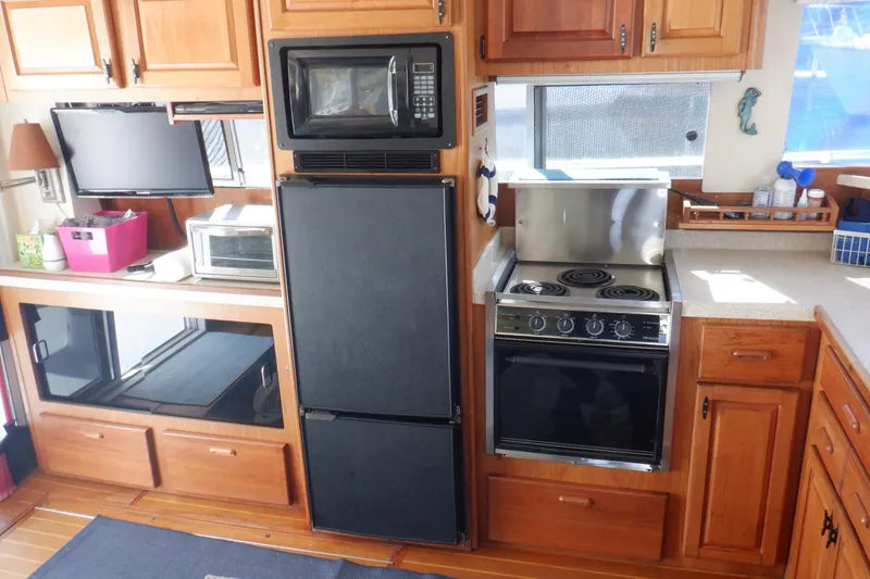 Slide: The Image of Kitchen area on a 1999 Mainship 350 Trawler with appliances. - 37