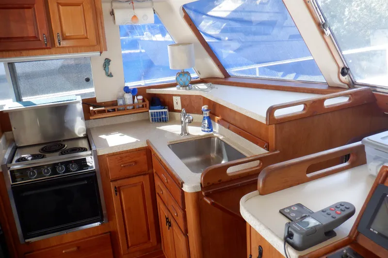 Slide: The Image of Interior of 1999 Mainship 350 Trawler with kitchen and sink. - 38