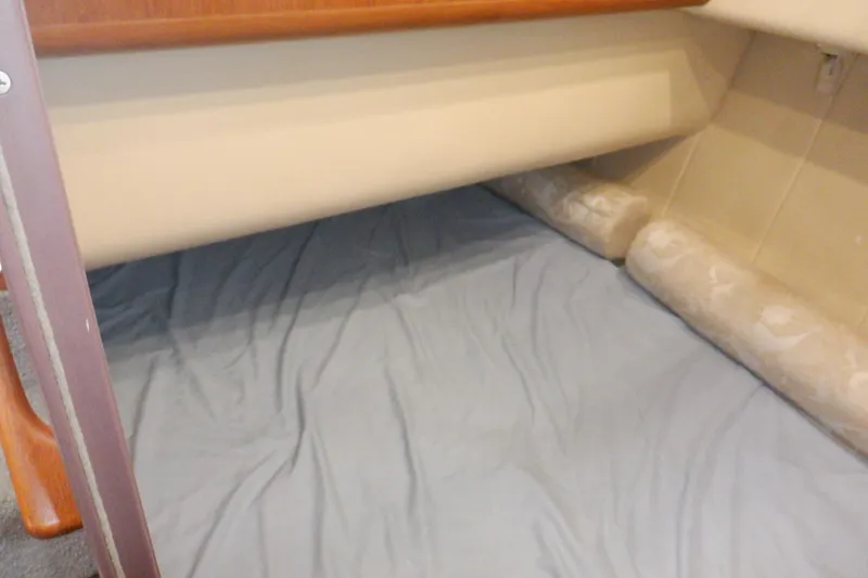 Slide: The Image of Interior cabin view of a 1999 Mainship 350 Trawler with bedding. - 41