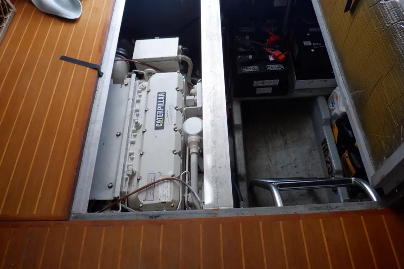Slide: The Image of Engine compartment of a 1999 Mainship 350 Trawler with Caterpillar engine and batteries. - 48
