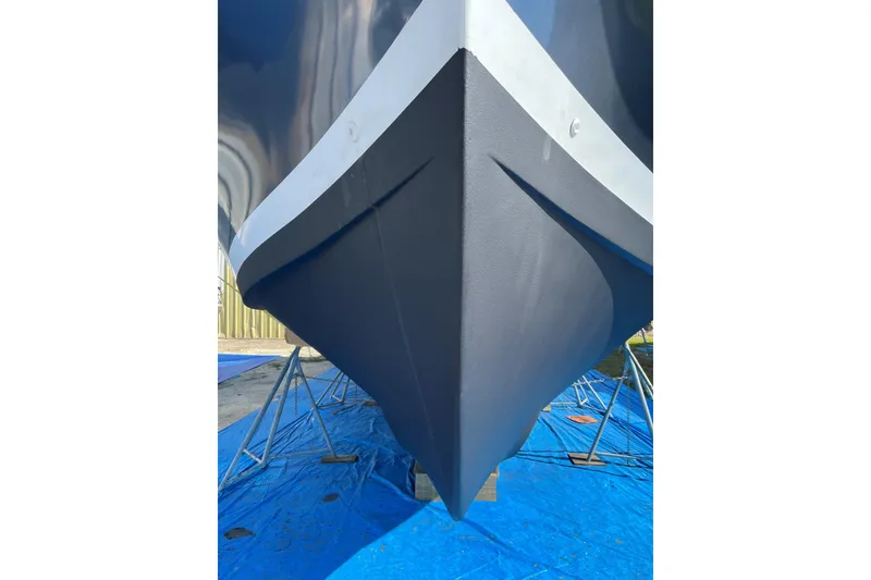 Slide: The Image of 1999 Mainship 350 Trawler bow on blue tarp, supported by stands. - 62