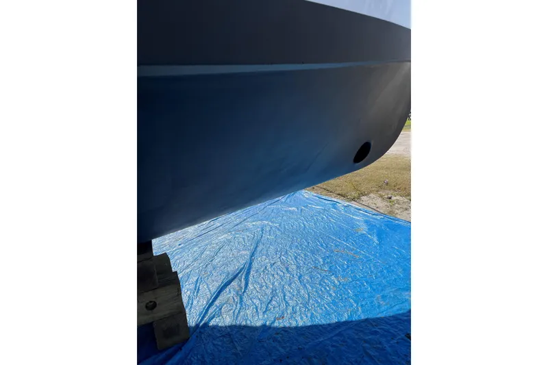 Slide: The Image of Bottom view of 1999 Mainship 350 Trawler on blue tarp, showcasing hull details. - 64