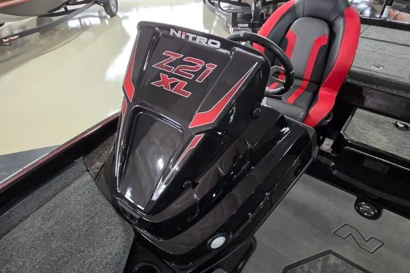 Slide: The Image of 2026 Nitro Z21 XL Pro boat interior with steering console and red-accented seat. - 12