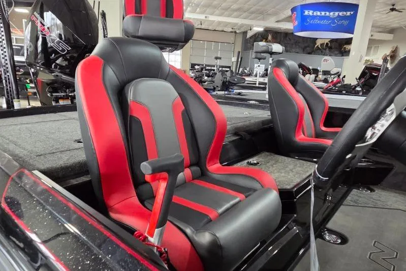 Slide: The Image of 2026 Nitro Z21 XL Pro boat interior with red and black seats in showroom. - 14