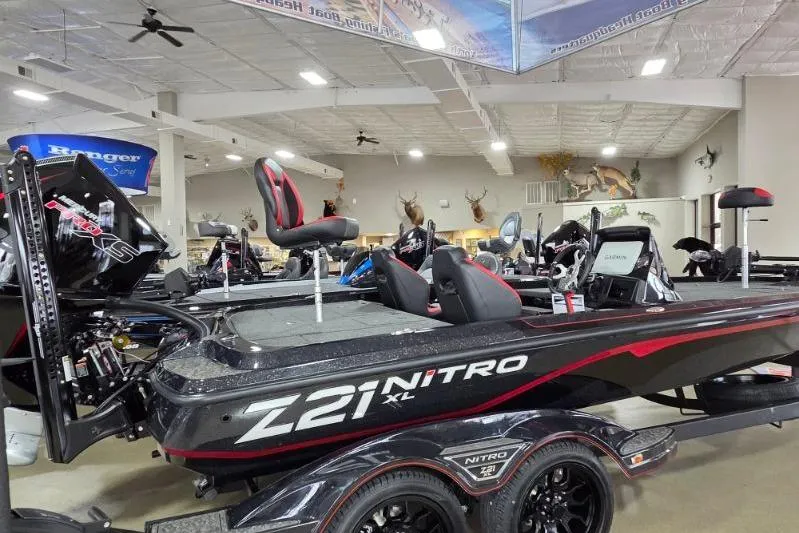 Slide: The Image of 2026 Nitro Z21 XL Pro boat displayed in showroom with sleek design and modern features. - 2