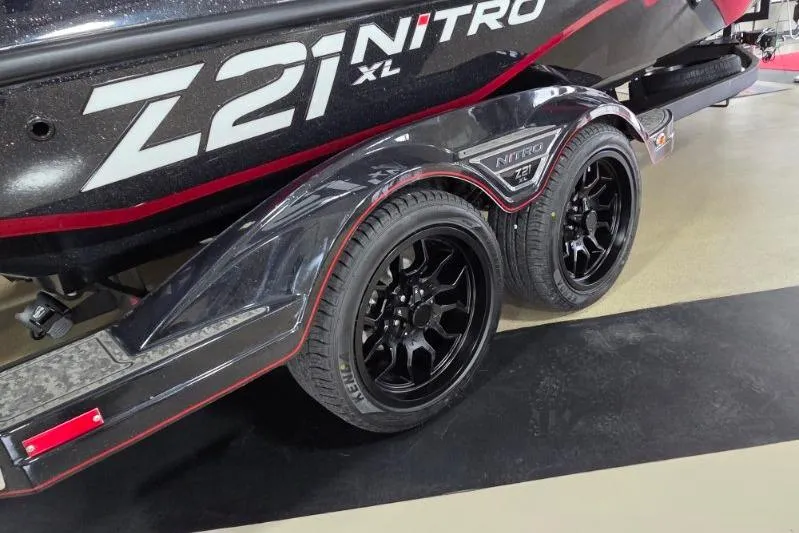 Slide: The Image of 2026 Nitro Z21 XL Pro boat trailer with black wheels and sleek design. - 3