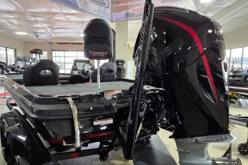 Slide: The Image of 2026 Nitro Z21 XL Pro boat in showroom, featuring sleek black design and powerful engine. - 6