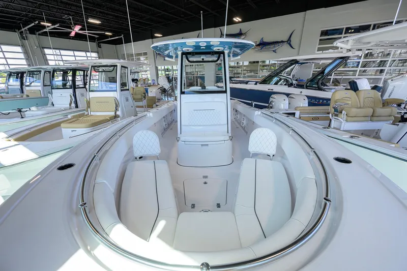 Slide: The Image of 2026 Sportsman Open 252 Center Console boat in showroom, featuring sleek design and spacious seating. - 16