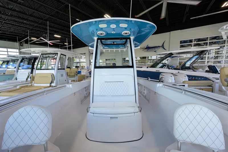 Slide: The Image of 2026 Sportsman Open 252 Center Console boat interior in showroom setting. - 17