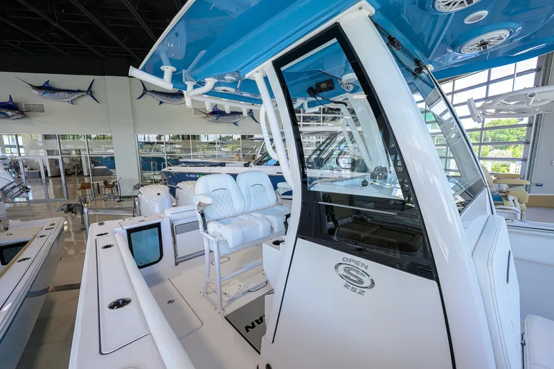 Slide: The Image of 2026 Sportsman Open 252 Center Console boat interior in showroom, featuring sleek design and seating. - 22