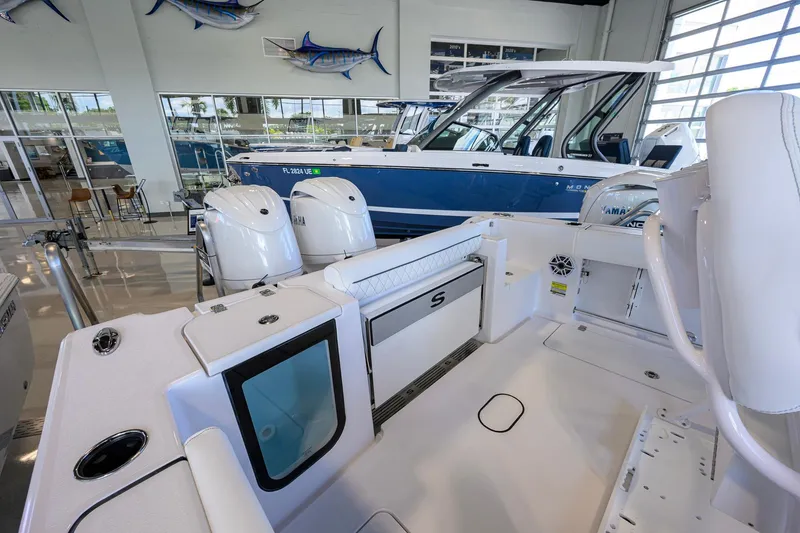 Slide: The Image of 2026 Sportsman Open 252 Center Console boat interior with dual Yamaha engines in showroom. - 25