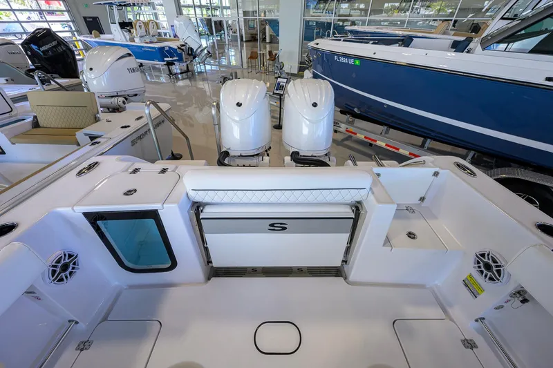 Slide: The Image of 2026 Sportsman Open 252 Center Console boat interior with dual engines in showroom. - 27
