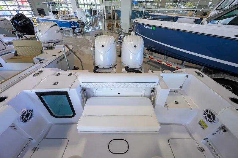 Slide: The Image of 2026 Sportsman Open 252 Center Console boat interior with dual engines in showroom. - 28