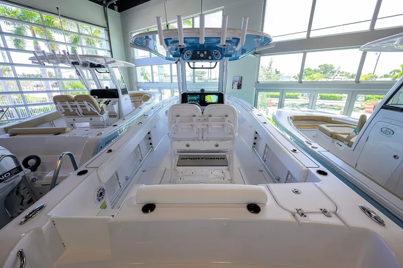 Slide: The Image of 2026 Sportsman Open 252 Center Console boat interior in showroom with modern features. - 31