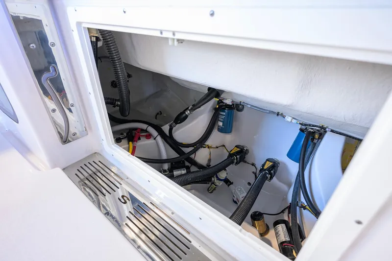 Slide: The Image of 2026 Sportsman Open 252 Center Console boat wiring and components inside compartment. - 37