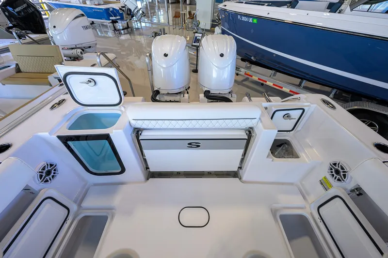 Slide: The Image of 2026 Sportsman Open 252 Center Console boat interior with dual engines and storage compartments. - 39