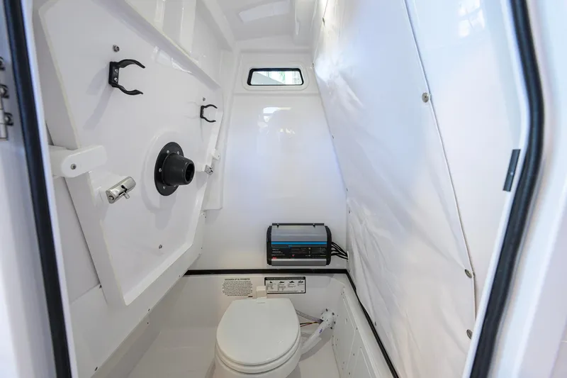 Slide: The Image of Interior of 2026 Sportsman Open 252 Center Console boat with compact marine toilet. - 40