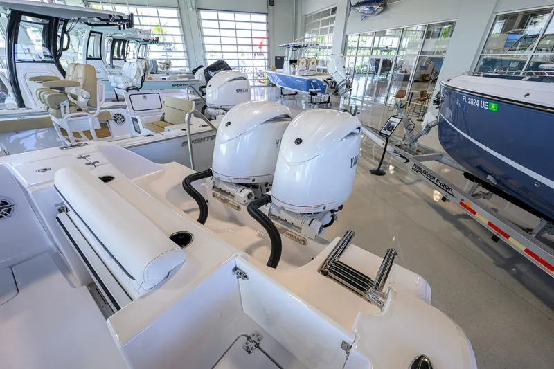 Slide: The Image of 2026 Sportsman Open 252 Center Console boat with dual engines in showroom. - 48