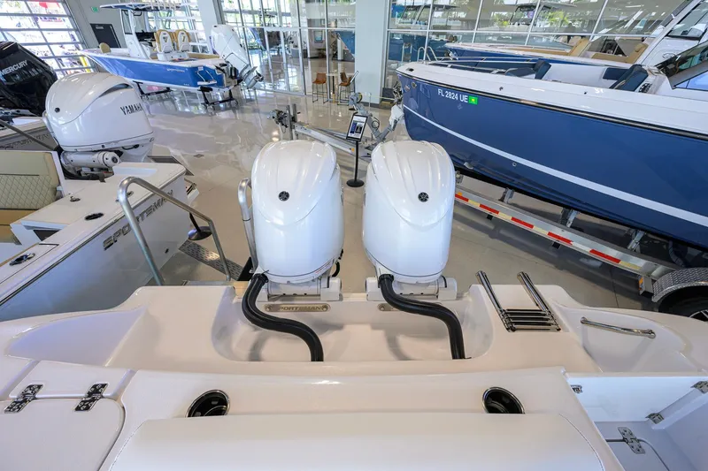 Slide: The Image of 2026 Sportsman Open 252 Center Console boat with dual Yamaha outboard engines in showroom. - 49