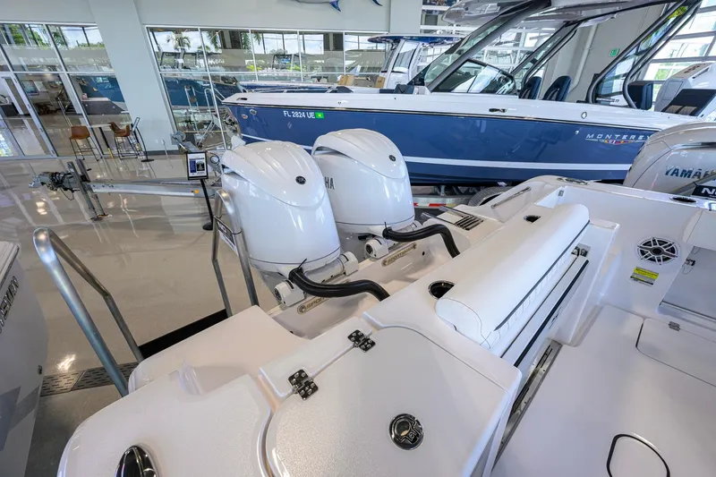 Slide: The Image of 2026 Sportsman Open 252 Center Console boat with dual Yamaha engines in showroom. - 50