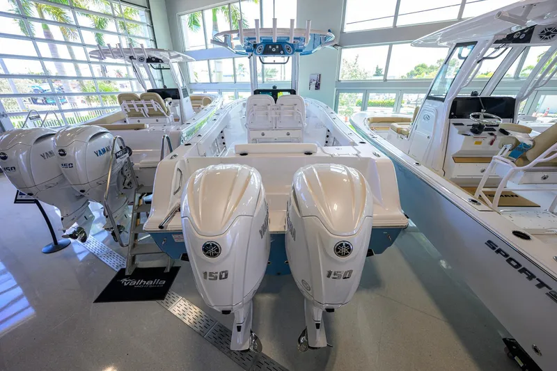 Slide: The Image of 2026 Sportsman Open 252 Center Console boat with dual Yamaha 150 engines in showroom. - 52